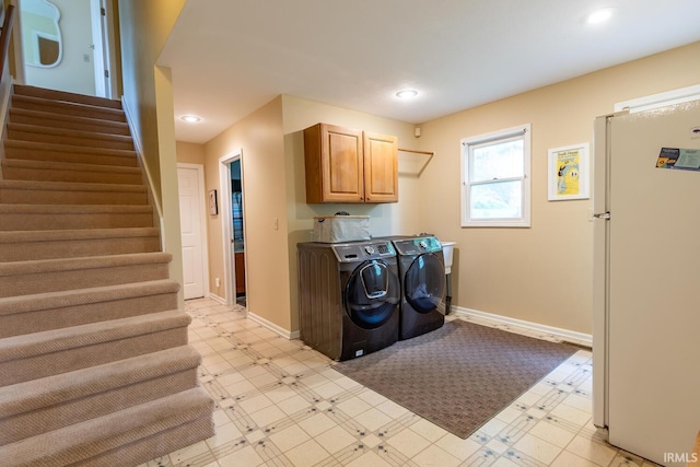 laundry area with cabinet space, recessed lighting, washing machine and dryer, and light floors