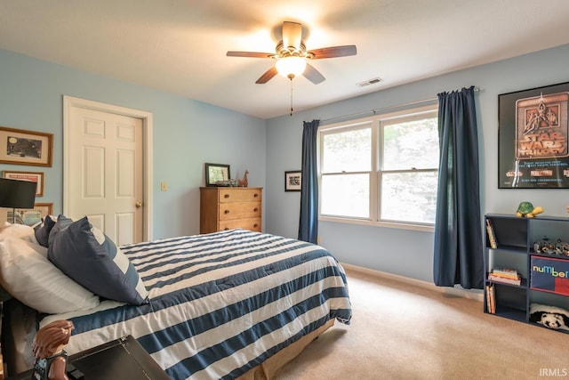 carpeted bedroom with a ceiling fan, baseboards, and visible vents