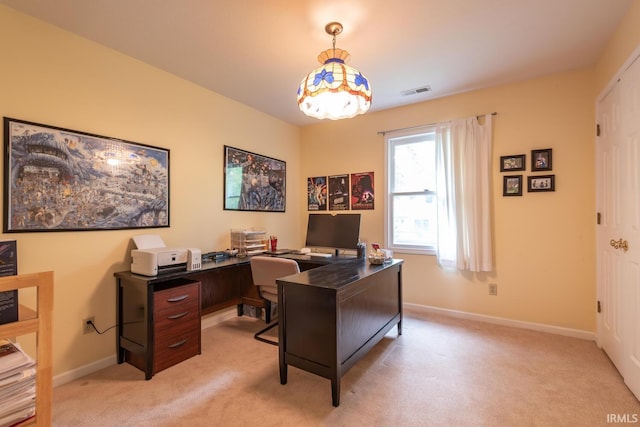 office with baseboards, visible vents, and light carpet