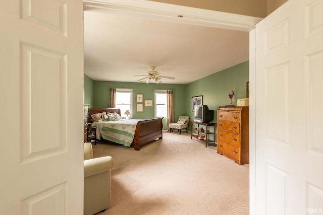 bedroom with ceiling fan and light carpet