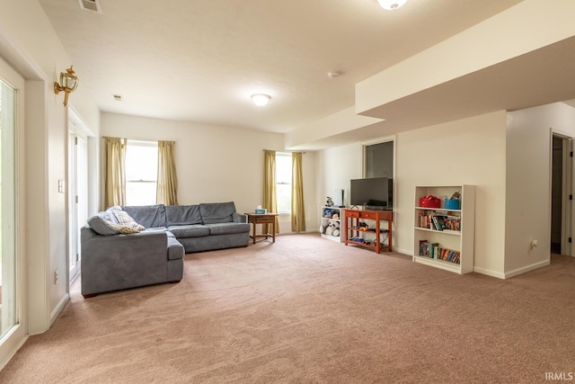 living area with baseboards and carpet