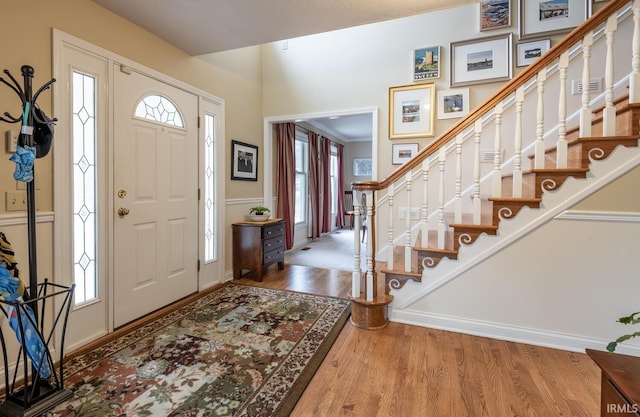 foyer featuring stairway and wood finished floors