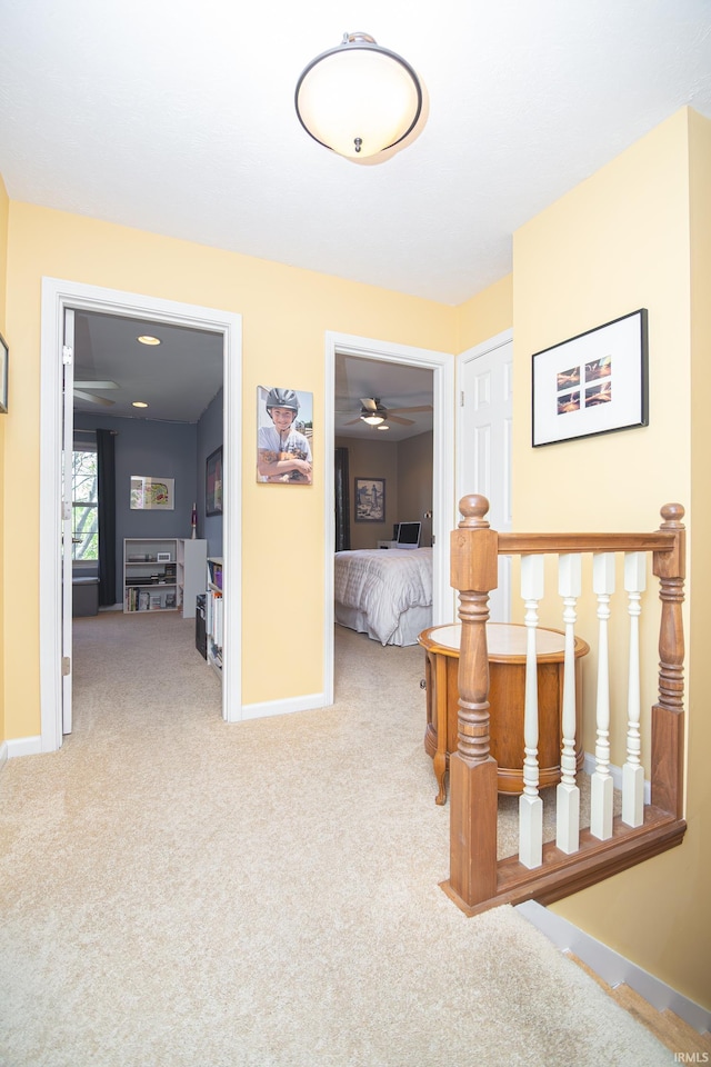 hall with carpet floors and baseboards