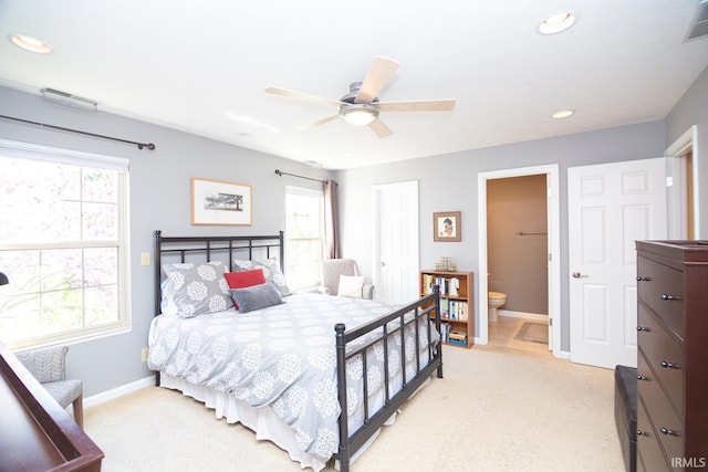 bedroom featuring baseboards, recessed lighting, connected bathroom, and light carpet