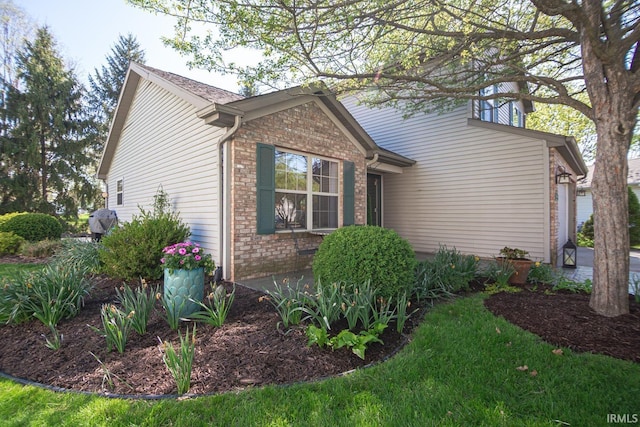 view of property exterior featuring brick siding