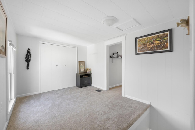 unfurnished bedroom featuring carpet, a closet, and visible vents
