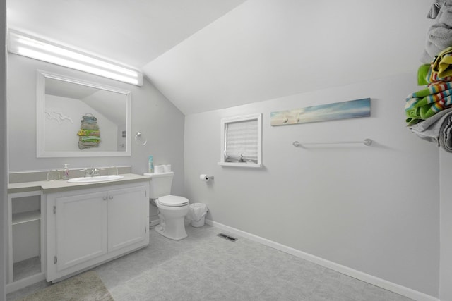 bathroom featuring vanity, toilet, baseboards, lofted ceiling, and visible vents