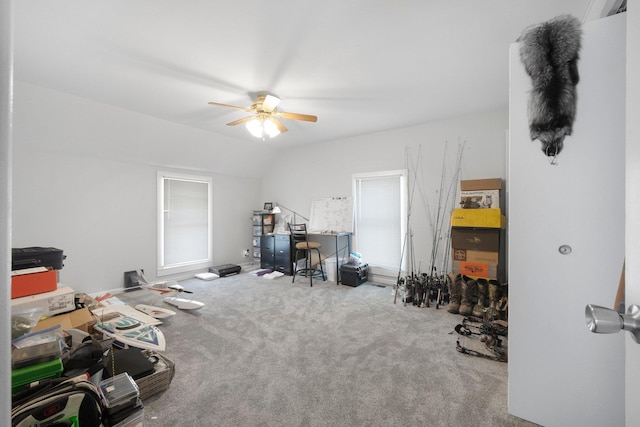 interior space featuring ceiling fan, carpet, and lofted ceiling