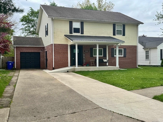 traditional-style house featuring a garage, a front yard, driveway, and brick siding