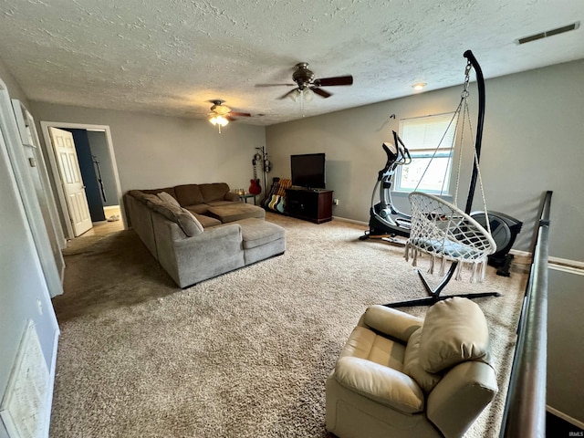 living room featuring a textured ceiling, ceiling fan, and carpet