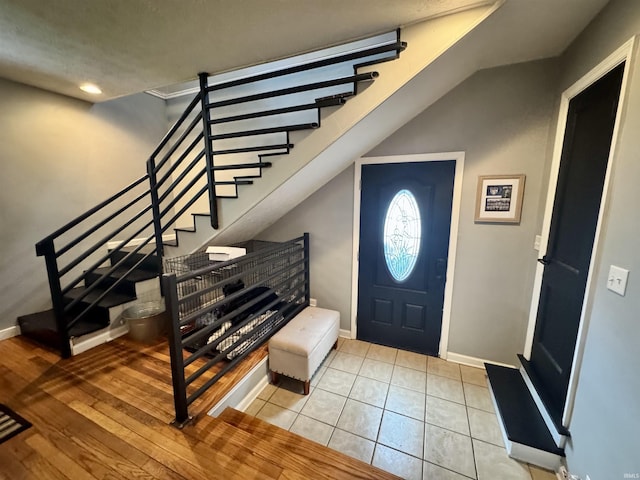 foyer with recessed lighting, baseboards, and stairway