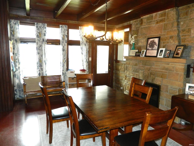 dining room featuring an inviting chandelier, wood ceiling, and beam ceiling