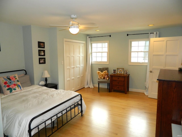 bedroom featuring light wood-style floors, baseboards, a closet, and recessed lighting