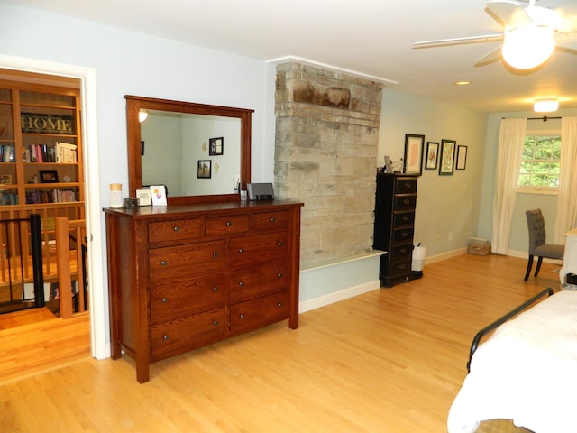 bedroom featuring light wood-type flooring, baseboards, and ceiling fan