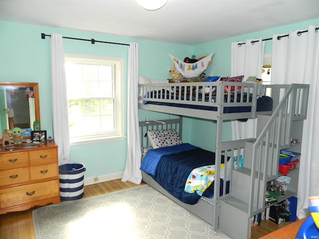 bedroom with baseboards and wood finished floors