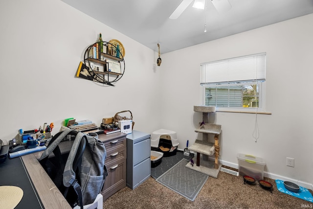office area with baseboards, ceiling fan, and dark colored carpet
