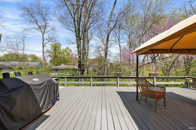 wooden deck with a gazebo and grilling area
