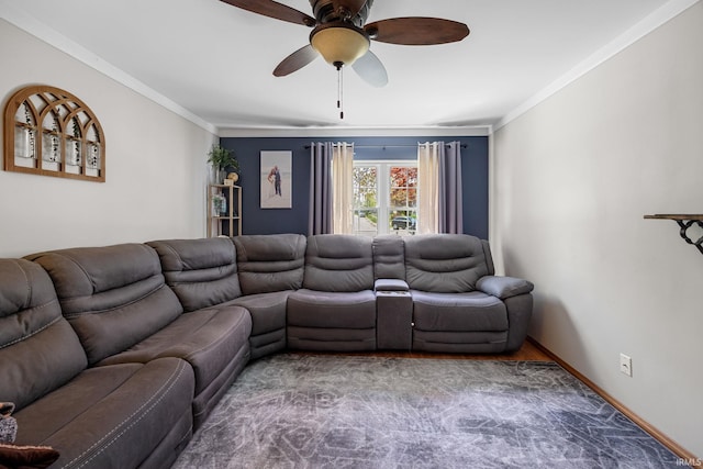 living room with crown molding, baseboards, ceiling fan, and wood finished floors
