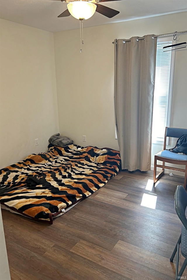 bedroom featuring ceiling fan and wood finished floors