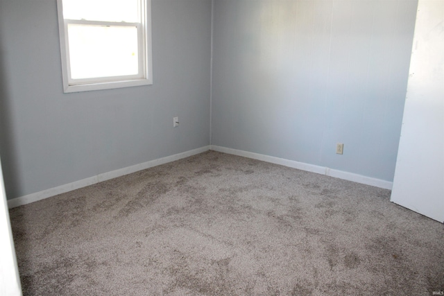 spare room with carpet flooring and baseboards