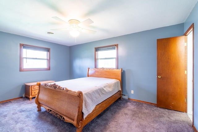 carpeted bedroom with visible vents, a baseboard radiator, baseboards, and multiple windows