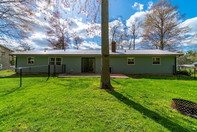 1360 N 140 W, Angola, IN 46703 - rear view of property featuring fence, a chimney, a patio area, metal roof, and a yard