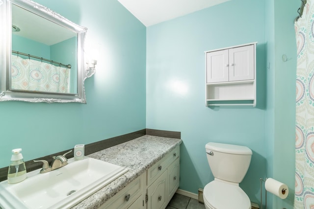 bathroom featuring vanity, tile patterned flooring, baseboards, and toilet