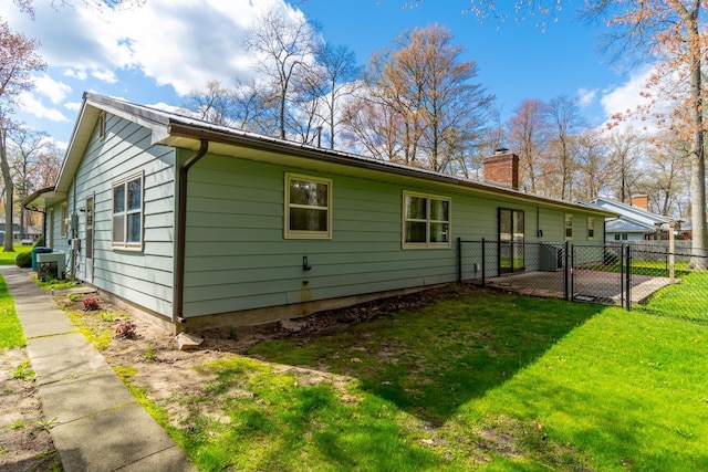 1360 N 140 W, Angola, IN 46703 - rear view of property featuring fence, a gate, a chimney, cooling unit, and a yard
