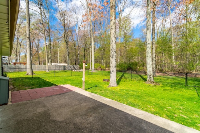 surrounding community with a lawn, a patio area, and fence