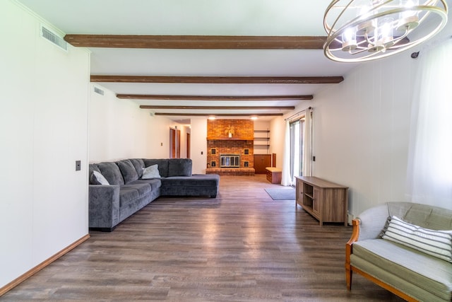 living area with visible vents, wood finished floors, and a notable chandelier
