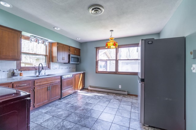 1360 N 140 W, Angola, IN 46703 - kitchen with a sink, appliances with stainless steel finishes, a baseboard radiator, and a healthy amount of sunlight