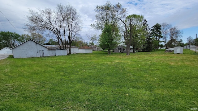 view of yard with a storage unit and an outbuilding