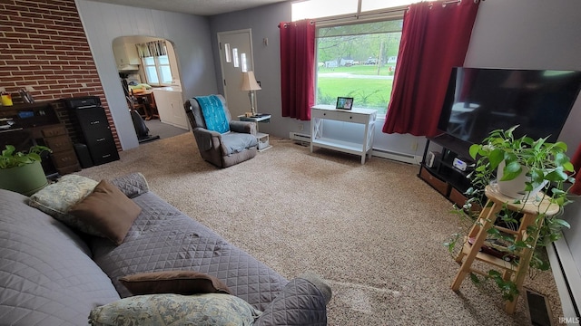 carpeted living room with arched walkways