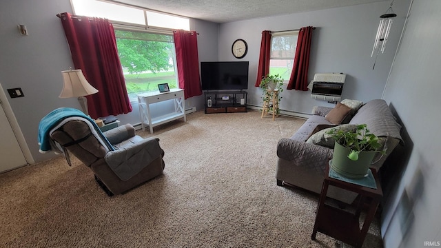 living room with heating unit, carpet flooring, a baseboard heating unit, and a textured ceiling