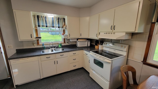 kitchen featuring dark countertops, a sink, under cabinet range hood, white appliances, and white cabinetry