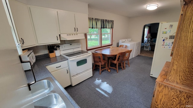 kitchen featuring arched walkways, separate washer and dryer, under cabinet range hood, white appliances, and white cabinetry