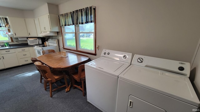 laundry area featuring laundry area, a sink, washing machine and dryer, and dark colored carpet