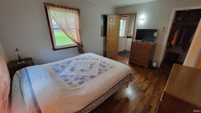 bedroom with dark wood-style floors