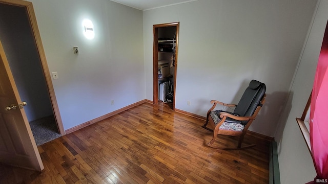 unfurnished room with baseboards, ornamental molding, and hardwood / wood-style floors