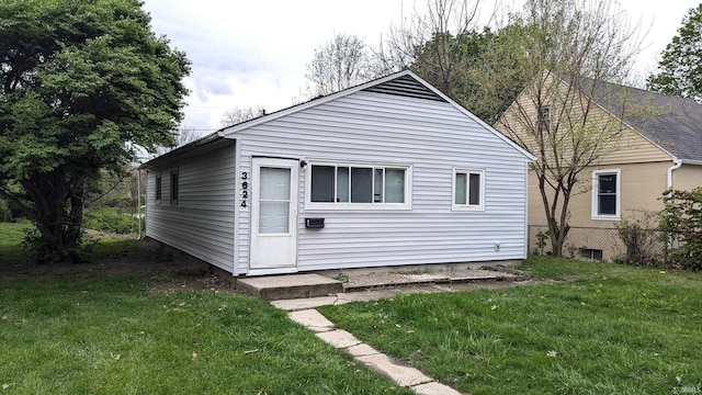 rear view of property with a yard