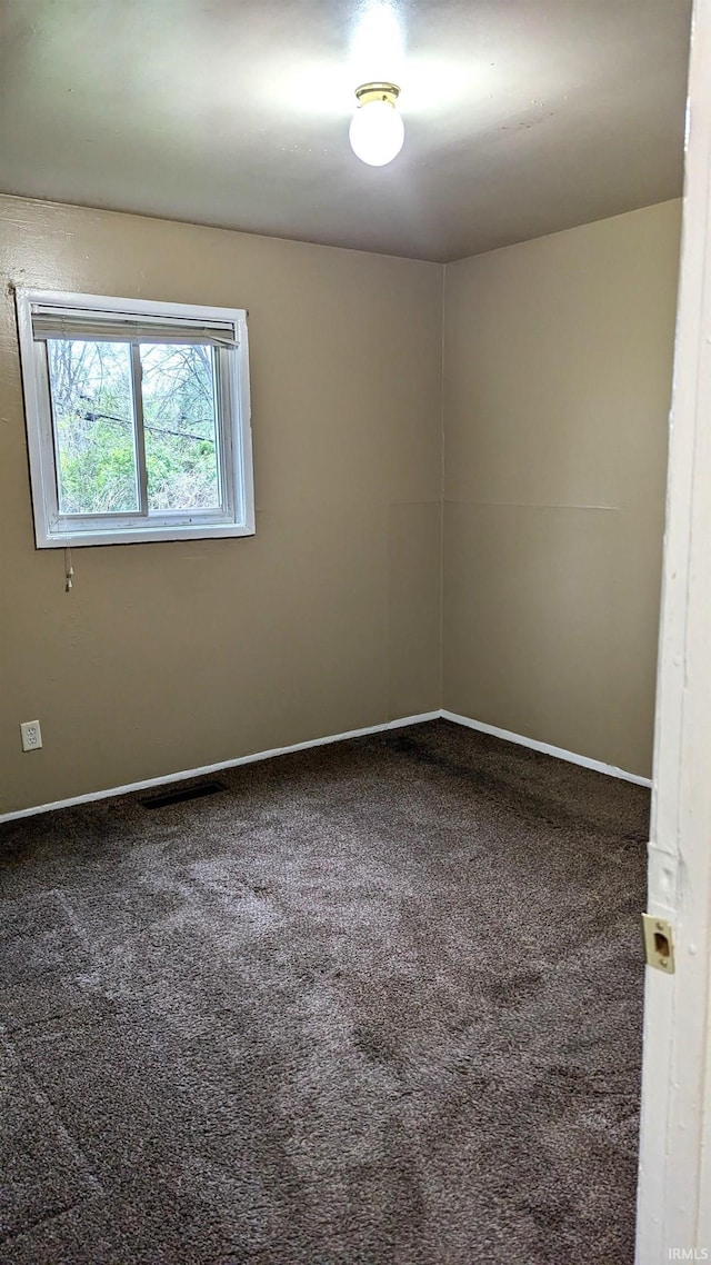 spare room with carpet floors and baseboards