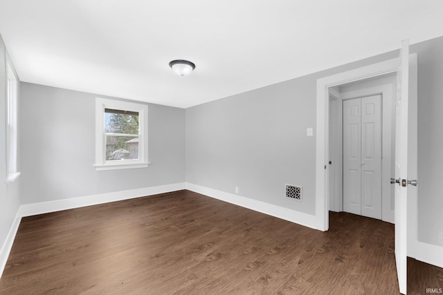 2922 Plaza Dr, Fort Wayne, IN 46806 - unfurnished room featuring baseboards, dark wood-type flooring, and visible vents