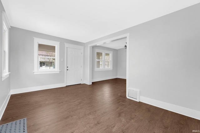 2922 Plaza Dr, Fort Wayne, IN 46806 - spare room with dark wood-style flooring, baseboards, visible vents, and ceiling fan