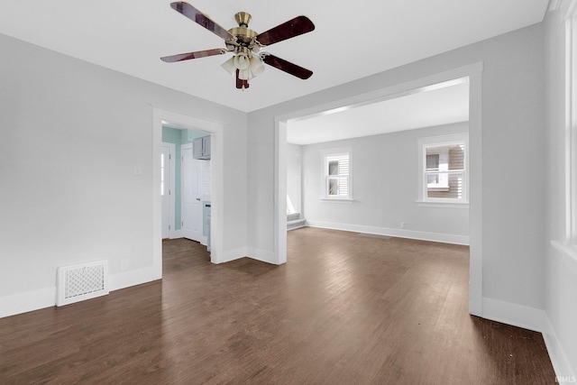 2922 Plaza Dr, Fort Wayne, IN 46806 - spare room featuring baseboards, ceiling fan, dark wood-style floors, and visible vents
