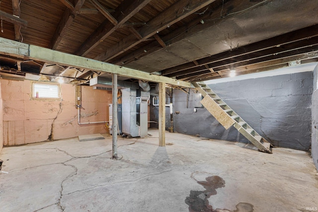 2922 Plaza Dr, Fort Wayne, IN 46806 - basement with heating unit, gas water heater, stairway, and electric panel