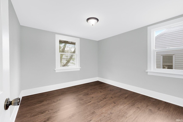 2922 Plaza Dr, Fort Wayne, IN 46806 - spare room featuring baseboards and dark wood-style flooring