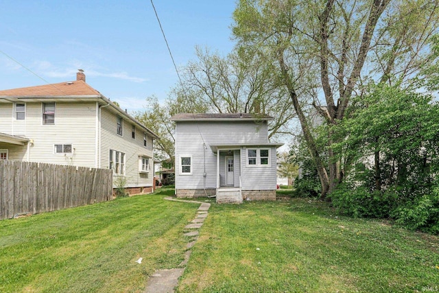 2922 Plaza Dr, Fort Wayne, IN 46806 - rear view of house with a lawn and fence