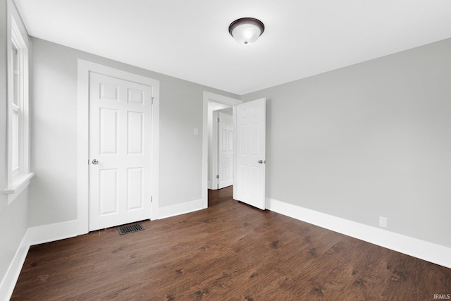 2922 Plaza Dr, Fort Wayne, IN 46806 - unfurnished bedroom with baseboards, wood finished floors, and visible vents