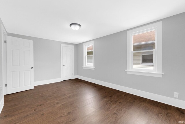 2922 Plaza Dr, Fort Wayne, IN 46806 - unfurnished bedroom featuring baseboards, a closet, and dark wood-style flooring