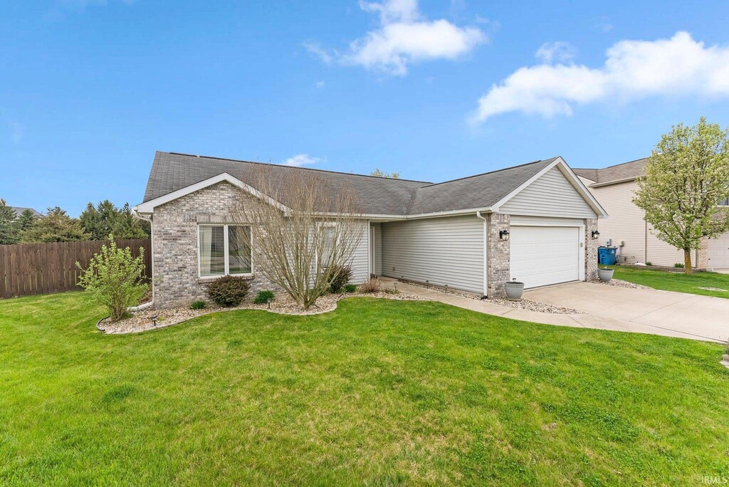809 Darwillow Ct, Huntertown, IN 46748 - ranch-style house with an attached garage, fence, brick siding, and concrete driveway